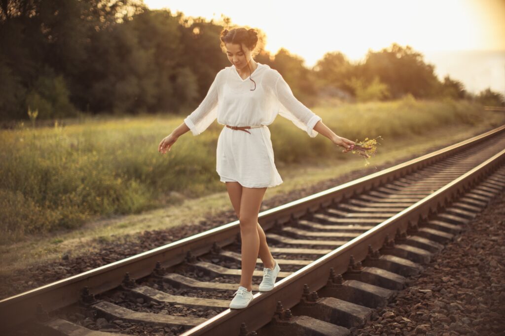 Girl Balancing on Train Rail